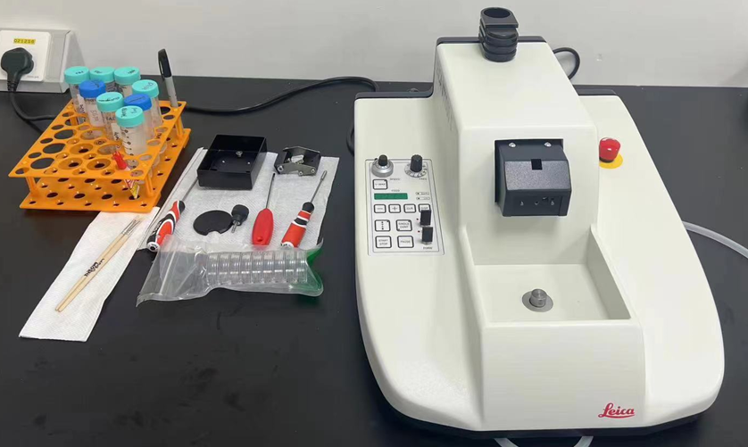 A white machine with buttons and screwdrivers

Description automatically generated